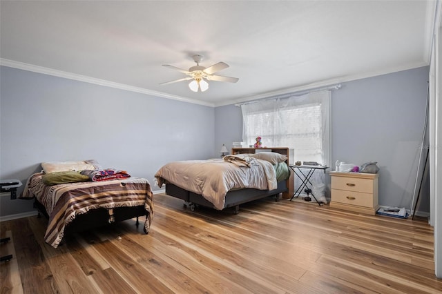 bedroom featuring ornamental molding, hardwood / wood-style floors, and ceiling fan