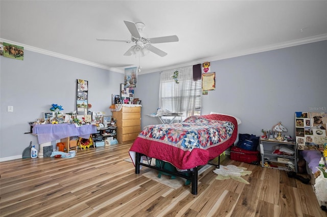 bedroom with crown molding, hardwood / wood-style flooring, and ceiling fan