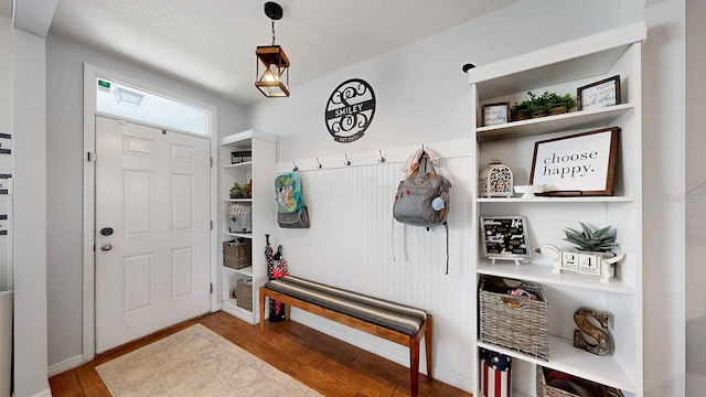 mudroom featuring wood-type flooring and a textured ceiling