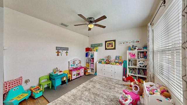 game room with ceiling fan and carpet floors