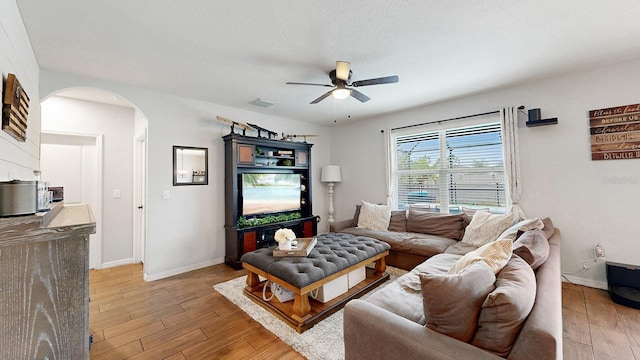 living room with light hardwood / wood-style floors and ceiling fan