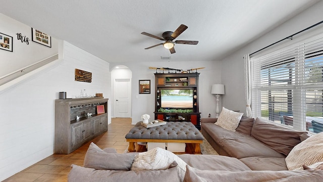 living room featuring a textured ceiling and ceiling fan