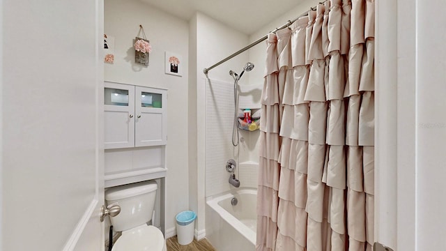 bathroom with shower / bath combination with curtain, hardwood / wood-style floors, and toilet