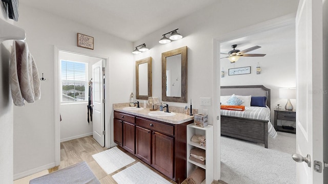 bathroom featuring wood-type flooring, vanity, and ceiling fan