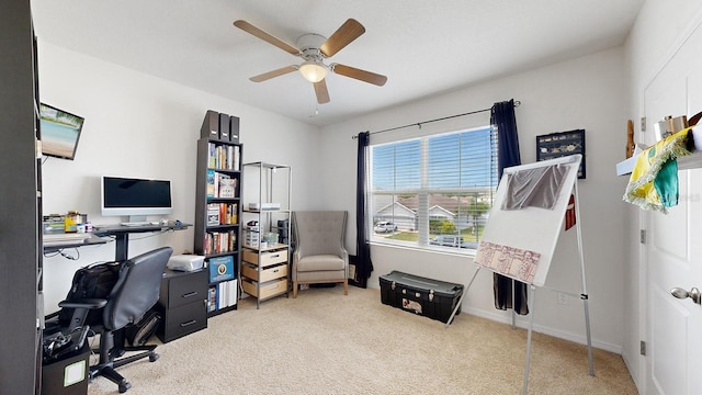 office space featuring light carpet and ceiling fan