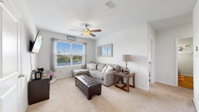 living room with ceiling fan and light carpet