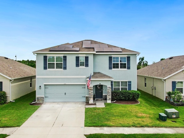 view of front of property with a front lawn, solar panels, and a garage