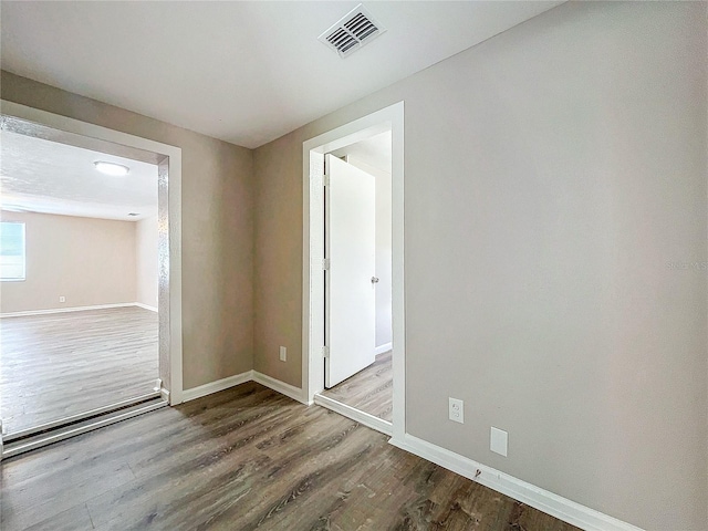 unfurnished room featuring hardwood / wood-style flooring