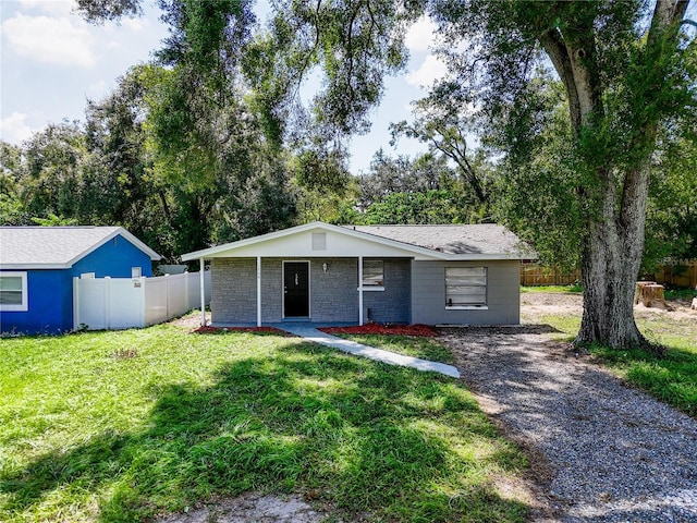 ranch-style home featuring a front yard