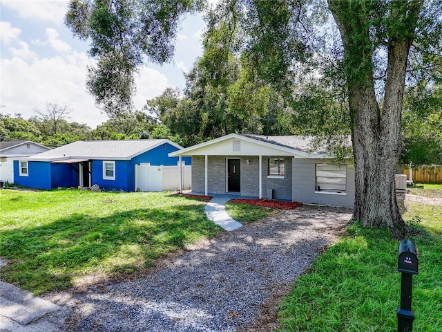 ranch-style house with cooling unit and a front yard