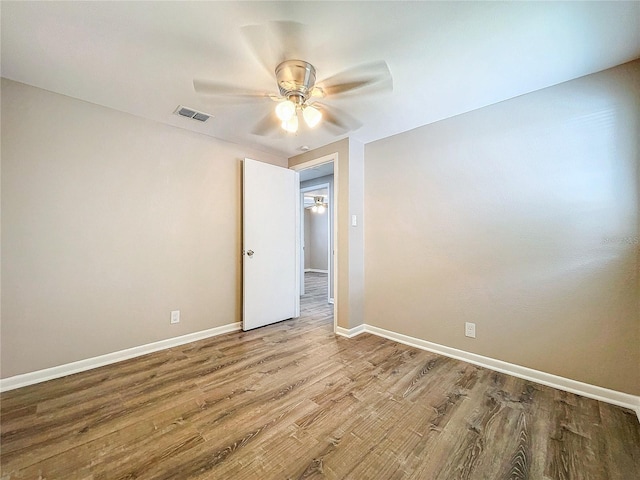 empty room featuring ceiling fan and hardwood / wood-style floors