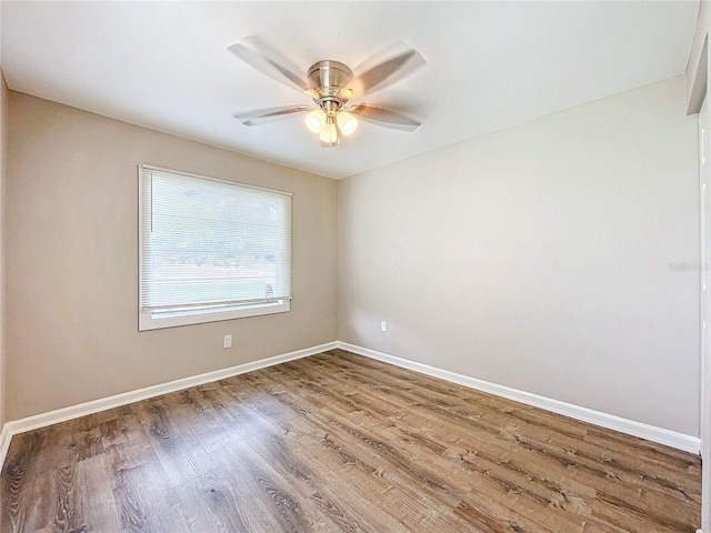 unfurnished room with ceiling fan and hardwood / wood-style flooring