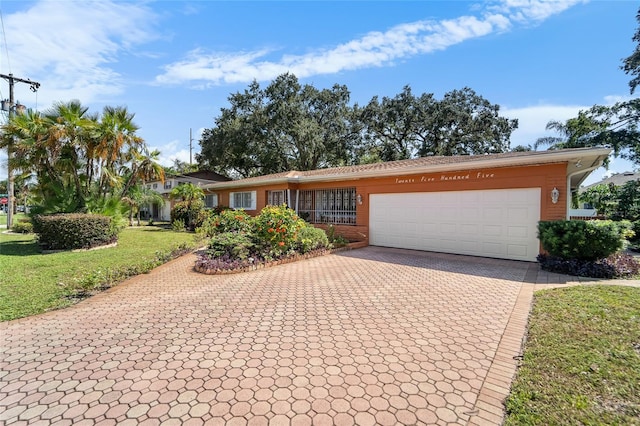 single story home featuring a garage and a front yard