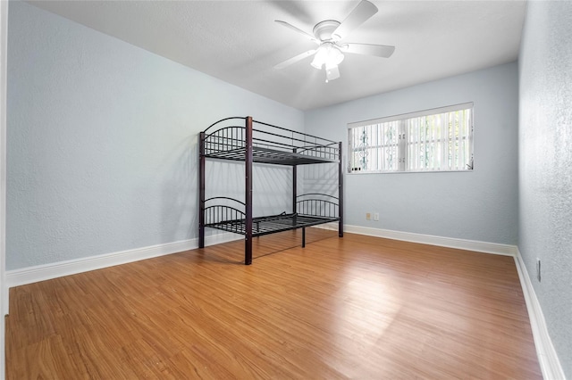 unfurnished bedroom featuring ceiling fan and hardwood / wood-style floors