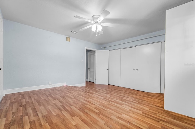 unfurnished bedroom featuring light hardwood / wood-style flooring, a closet, and ceiling fan