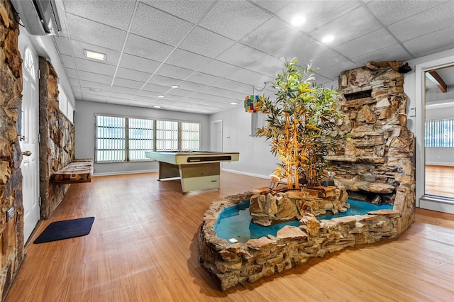 interior space with wood-type flooring, billiards, and a paneled ceiling