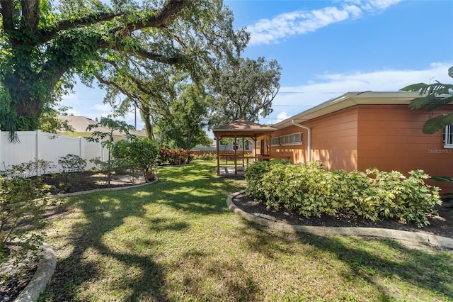 view of yard featuring a deck and a gazebo