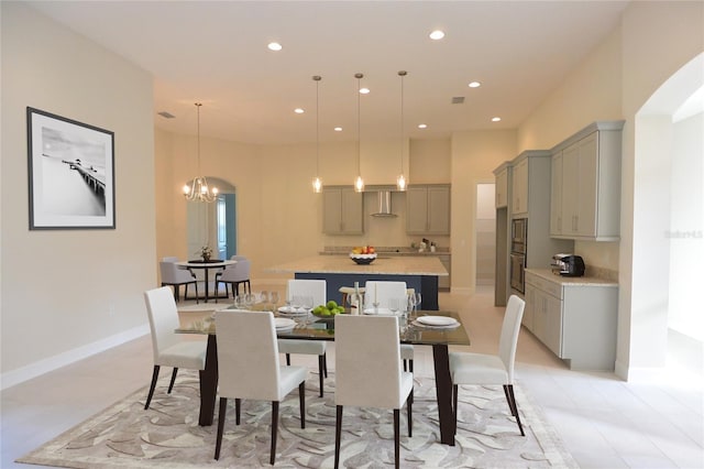 tiled dining area with a chandelier