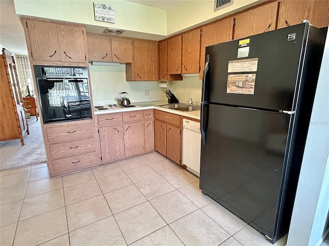 kitchen with light tile patterned flooring, sink, and black appliances