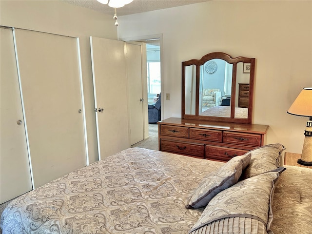 carpeted bedroom with a textured ceiling