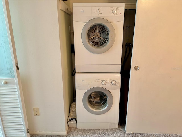 washroom featuring light carpet and stacked washer and dryer