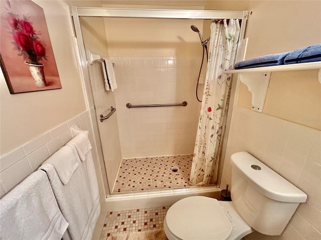 bathroom featuring walk in shower, tile walls, toilet, and tile patterned floors