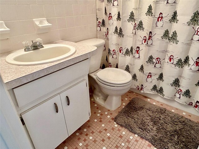 bathroom featuring tile walls, tile patterned floors, vanity, and toilet