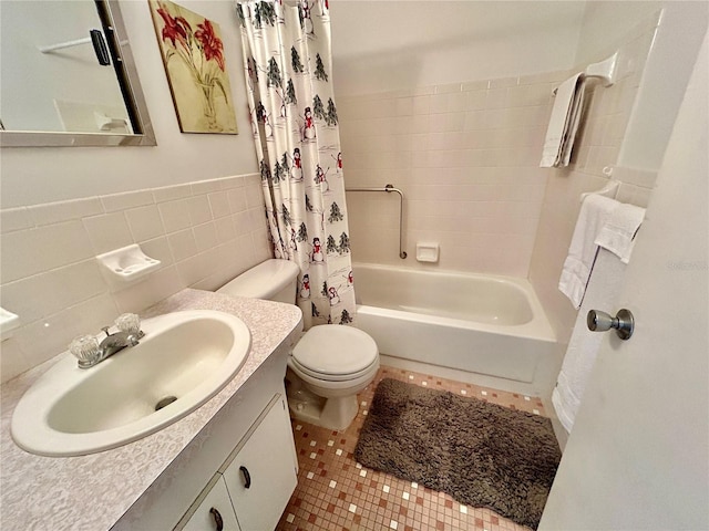 full bathroom with shower / bath combination with curtain, tile walls, tile patterned floors, vanity, and toilet