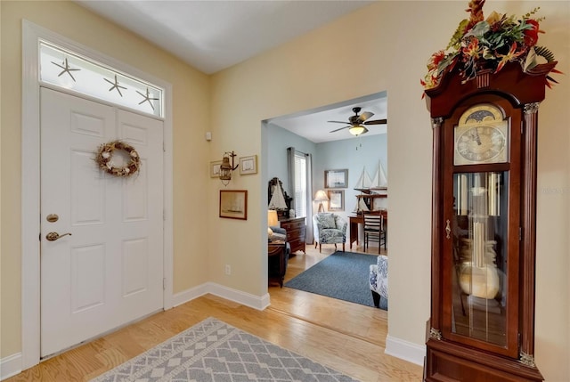 entrance foyer with ceiling fan and wood-type flooring