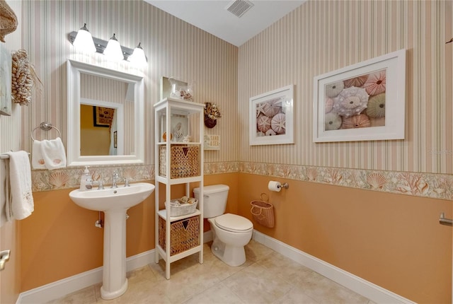 bathroom featuring tile patterned floors, toilet, and sink