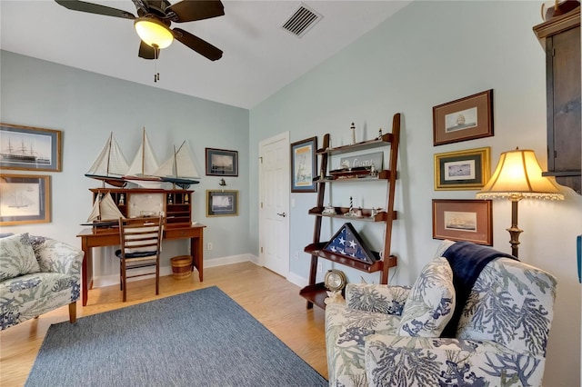 living area with ceiling fan and light hardwood / wood-style flooring