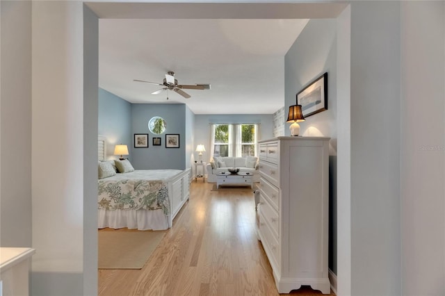 bedroom with light hardwood / wood-style floors and ceiling fan