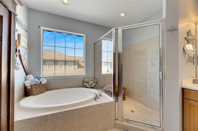 bathroom featuring shower with separate bathtub and vanity