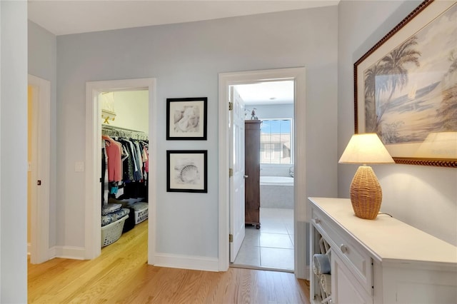 hallway with light hardwood / wood-style floors