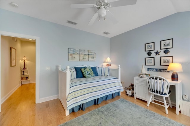 bedroom featuring light hardwood / wood-style floors, lofted ceiling, and ceiling fan