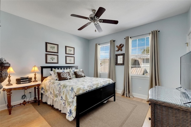 bedroom with hardwood / wood-style floors and ceiling fan