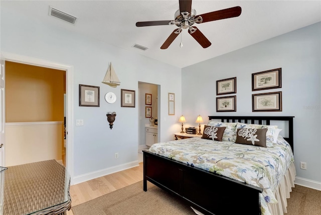 bedroom featuring light hardwood / wood-style flooring, ceiling fan, and connected bathroom