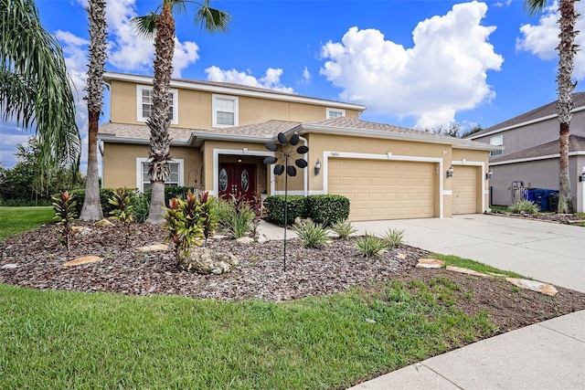 view of front of home featuring stucco siding, an attached garage, and concrete driveway
