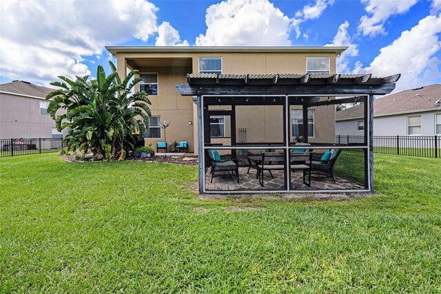 rear view of house with a pergola and a yard