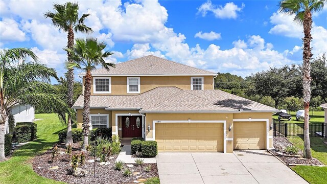 view of property with a front lawn and a garage