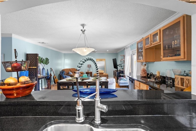 kitchen featuring a textured ceiling, sink, and ornamental molding