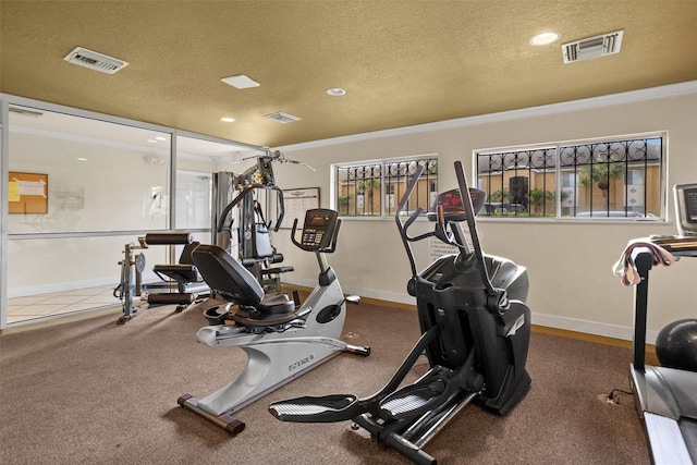 gym with a textured ceiling and ornamental molding