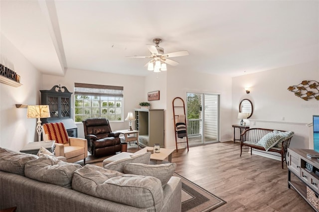 living room featuring ceiling fan and hardwood / wood-style flooring