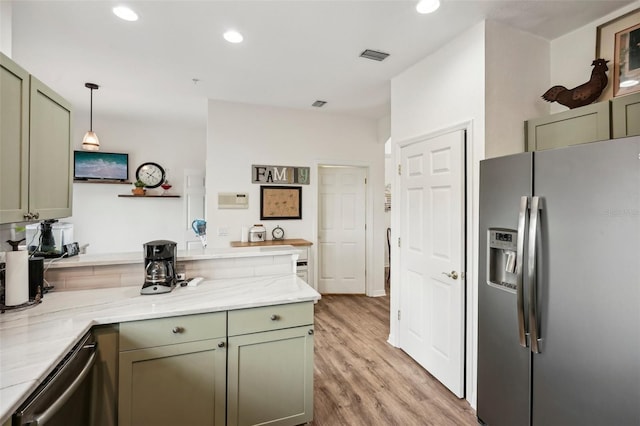 kitchen featuring light hardwood / wood-style floors, hanging light fixtures, stainless steel appliances, green cabinets, and light stone countertops