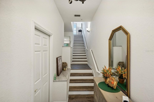 stairs featuring hardwood / wood-style floors