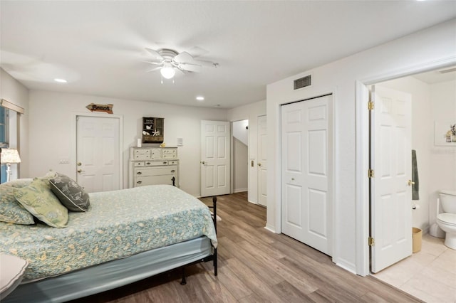 bedroom with ceiling fan, light hardwood / wood-style flooring, and ensuite bathroom