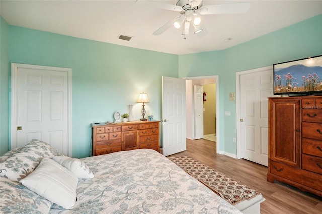 bedroom with light wood-type flooring and ceiling fan