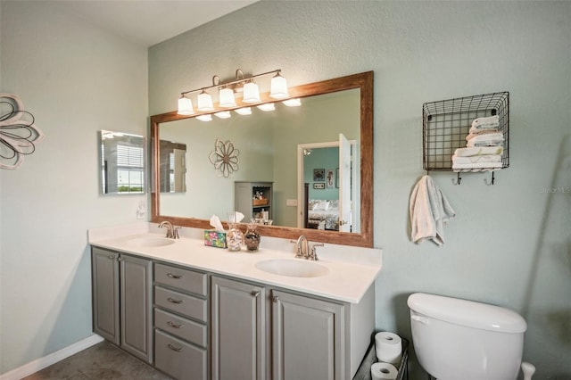 bathroom with vanity, toilet, and tile patterned floors