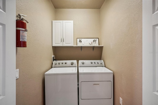 washroom featuring cabinets and washer and dryer