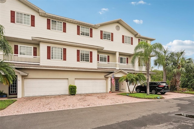 view of front of home featuring a balcony and a garage